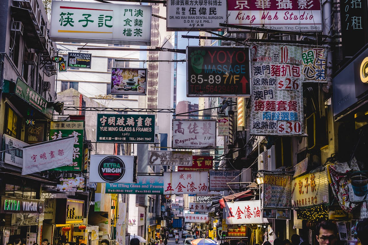 services-03 Vibrant urban street filled with numerous bright signs in Hong Kong, showcasing local businesses and culture.